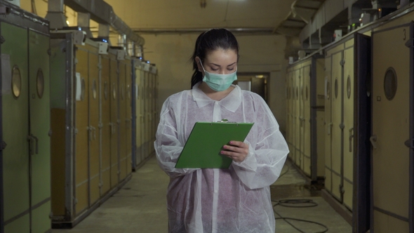 Woman Inspector Write Report after Checking Incubators alt