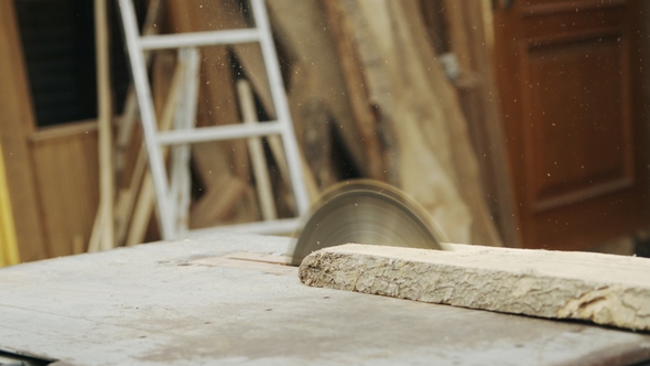 Senior Man Sawing Wood on the Machine with a Circular Saw