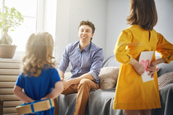 daughters congratulating dad - Stock Photo - Images