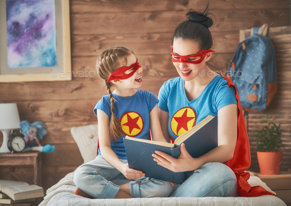 Girl and mom in Superhero costume - Stock Photo - Images