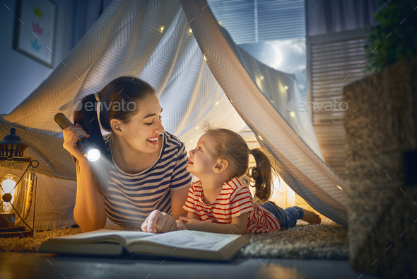 Mom and child reading a book Stock Photo by choreograph | PhotoDune