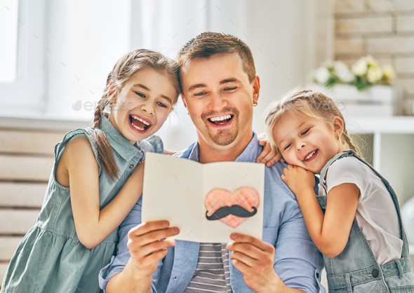 daughters congratulating dad - Stock Photo - Images
