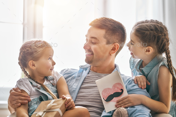daughters congratulating dad - Stock Photo - Images