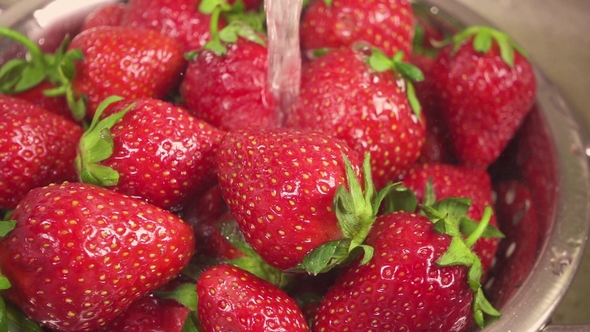 Strawberry in a Metal Colander under the Water