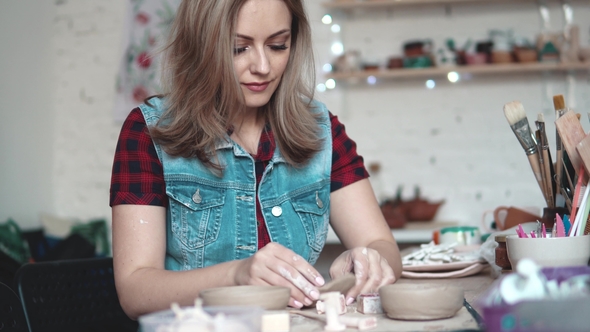 Attractive Young Caucasian Woman Spends Time Behind a Creative Hobby. the Girl Enthusiastically