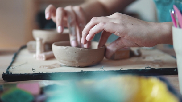 Girl Is Busy with Creative Work. the Process of Creating a Dish of Clay. Female Hands