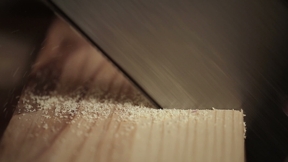 Sawing Wooden Board with Hand Saw
