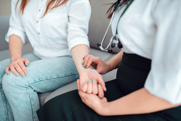 Family doctor check heart rate of a young mother - Stock Photo - Images