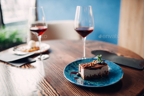 Dessert on plate and red wine in glass, nobody - Stock Photo - Images
