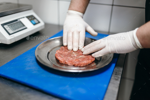 Chef hands in gloves prepares meat, burger cooking Stock Photo by NomadSoul1