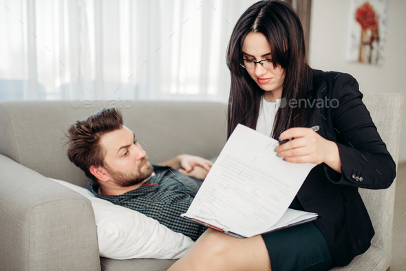Man lies on sofa at psychotherapist reception - Stock Photo - Images
