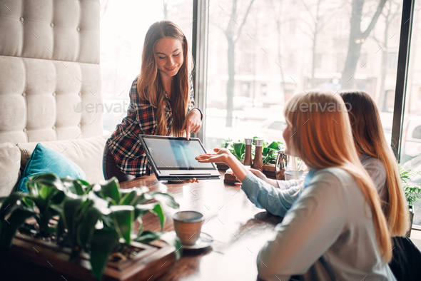 Presentation of goods on laptop, meeting in cafe - Stock Photo - Images