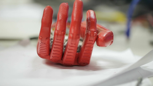 Artificial Bionic Arm Is Moving on Table in Technological Medical Laboratory. alt