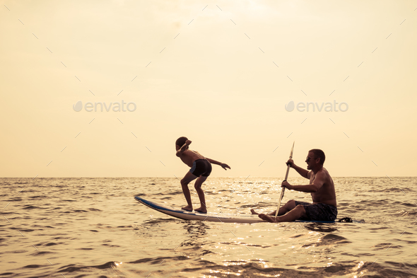 Father and son playing on the beach at the day time. - Stock Photo - Images