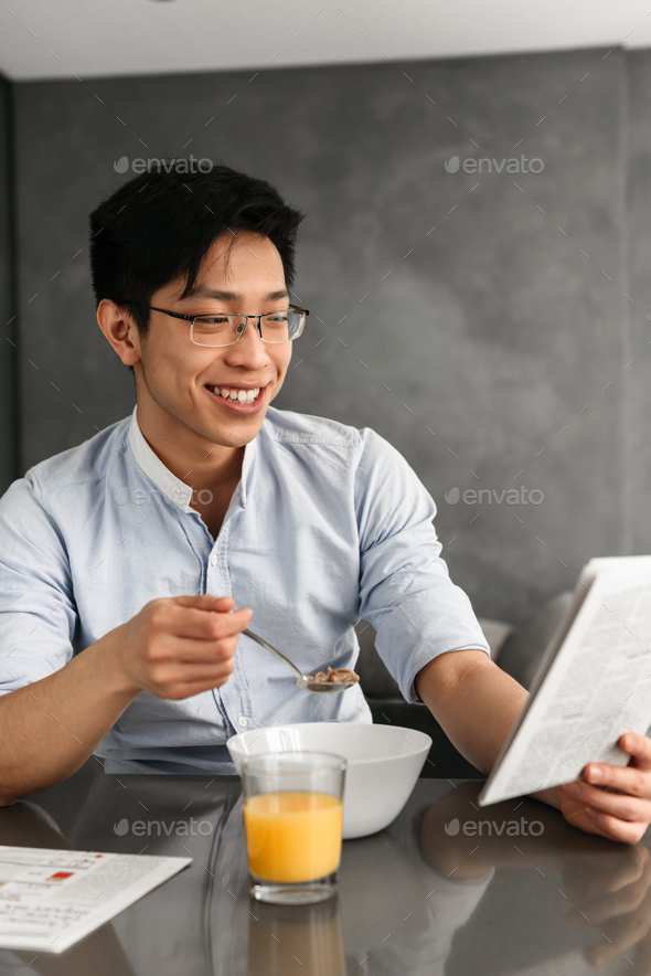 Portrait of a cheerful young asian man - Stock Photo - Images