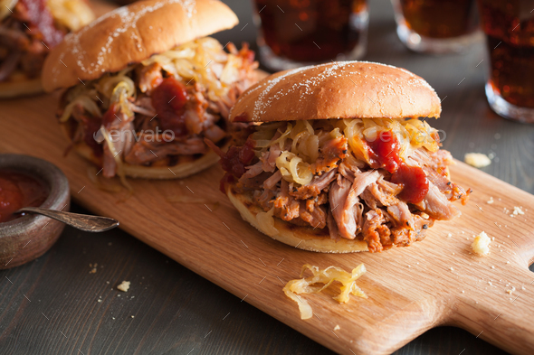 homemade pulled pork burger with caramelized onion and bbq sauce Stock Photo by duskbabe