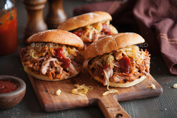 homemade pulled pork burger with caramelized onion and bbq sauce Stock Photo by duskbabe