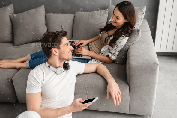 Photo of loving husband and wife in casual clothing resting in l - Stock Photo - Images