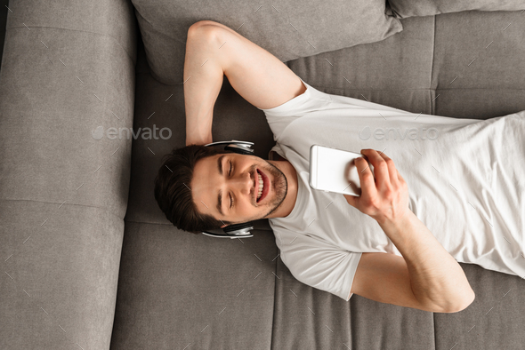 Photo from above of handsome masculine man 30s in white t-shirt - Stock Photo - Images