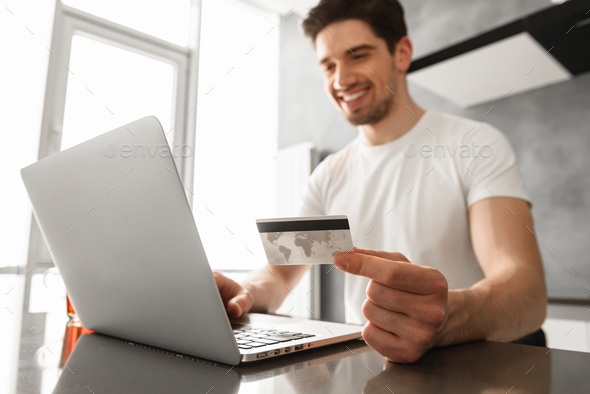 Photo of successful man 30s in casual clothing holding credit ca - Stock Photo - Images
