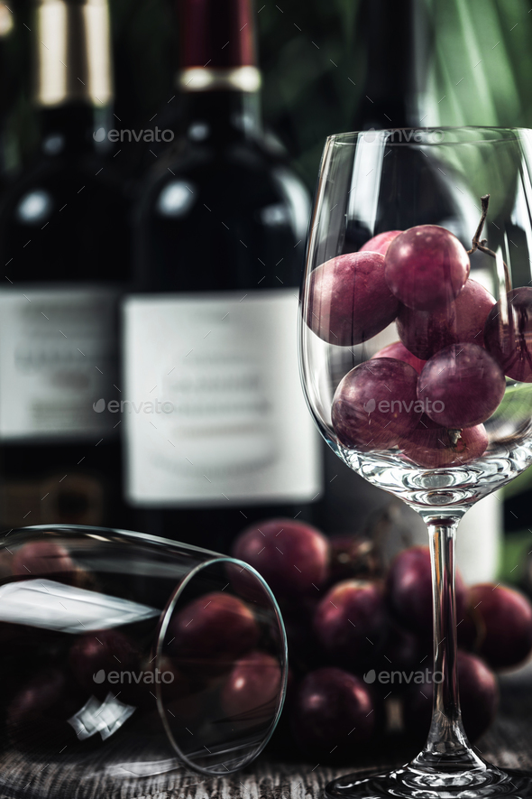 Bottles Of Red Wine, Wine Glasses And Grapes - Stock Photo - Images