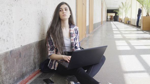 Student Girl in University with Laptop