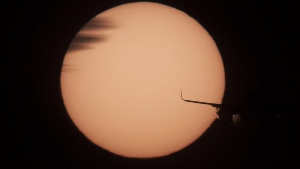 Jet Approaching To Landing with Sun Behind It