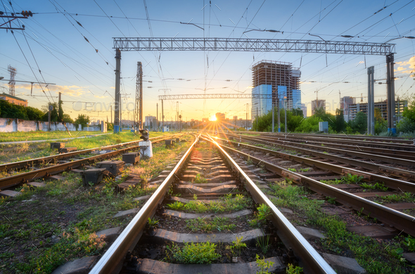 Industrial landscape with railway station, green grass, buildings - Stock Photo - Images