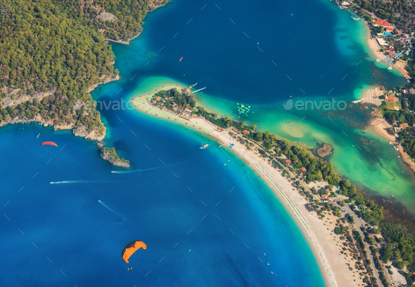 Colorful summer landscape with sea spit, green forest, azure water - Stock Photo - Images