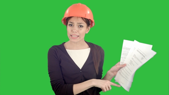 Angry Female Engineer in Hardhat with Documents Shouting and Pointing Finger Into the Camera on a alt