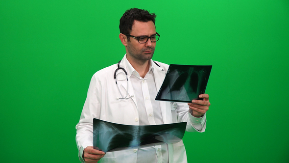 Doctor Analyzing X-Ray on Green Screen alt