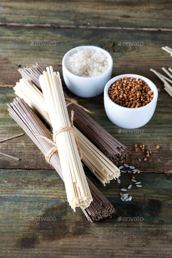 noodles soba and sommel, bowls with buckwheat and rice on an old wooden background - Stock Photo - Images