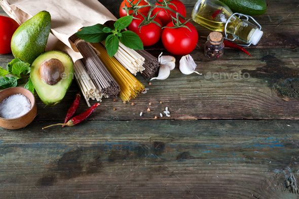 bunch of Italian spaghetti, noodles soba and sommel, chicken raw meat, avocado, zucchini with tomato - Stock Photo - Images