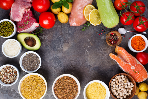 rustic assortment of paleo foods including, eggs, legumes, vegetables, fish, meat, muesli and pasta - Stock Photo - Images