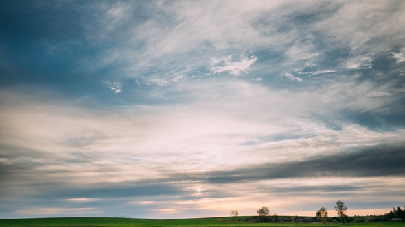 Spring Field At Evening Sunset. Natural Bright Dramatic Sky Pink Colours Abov alt
