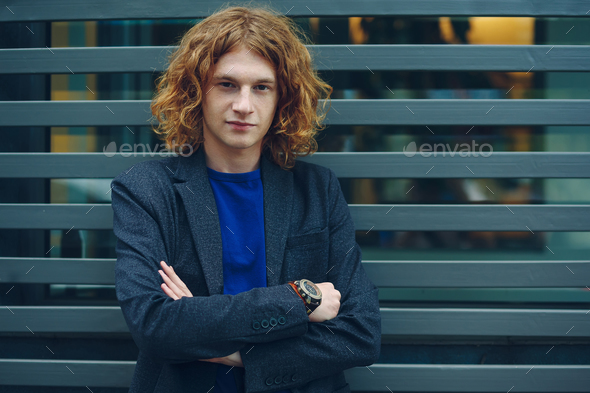 Curly man with crossed arms - Stock Photo - Images