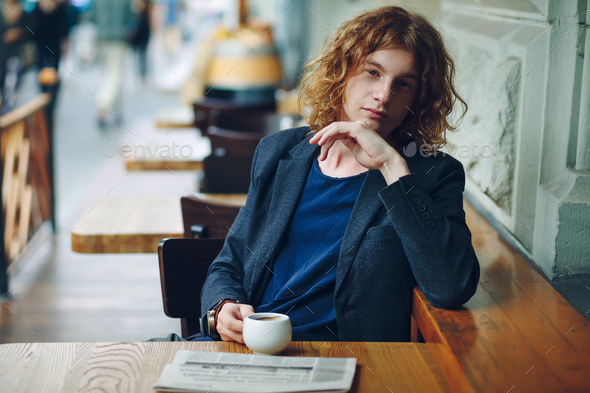 Portrait reddish hipster man with coffe and newspaper - Stock Photo - Images