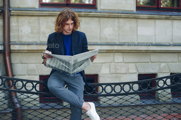 Man reading while resting - Stock Photo - Images