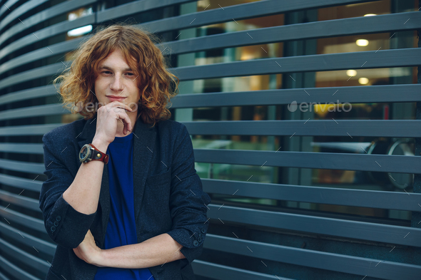 Portrait of red haired man over urban futuristic background - Stock Photo - Images