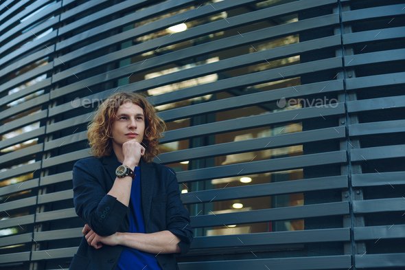 Portrait of red haired man over urban futuristic background - Stock Photo - Images