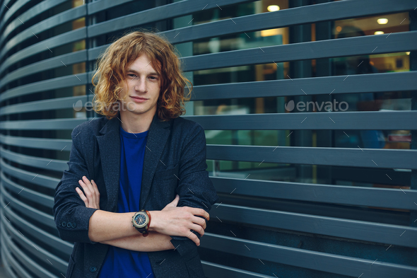 Portrait of red haired man over urban futuristic background - Stock Photo - Images