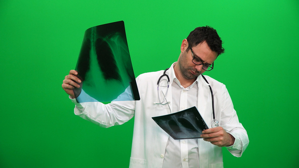 Doctor Examines Chest X-Ray On Green Screen alt
