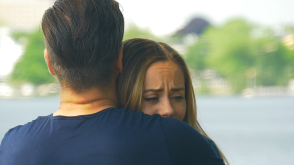 Saying Goodbye - a Man Comforting a Sad Woman