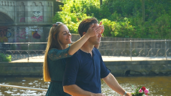 Romantic Date - Young Woman Is Greeting Her Boyfriend and Closing His Eyes with Her Hands