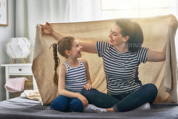Family playing under blanket - Stock Photo - Images