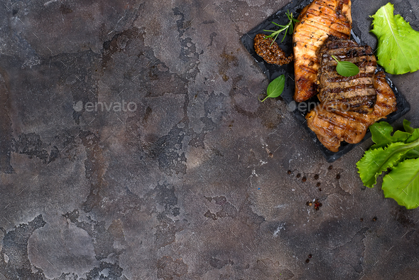 Fresh three types of grilled steak (chicken, pork, beef) on slate plate with herbs - Stock Photo - Images