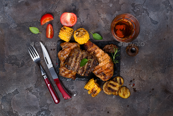 Fresh three types of grilled steak on slate plate with herbs - Stock Photo - Images
