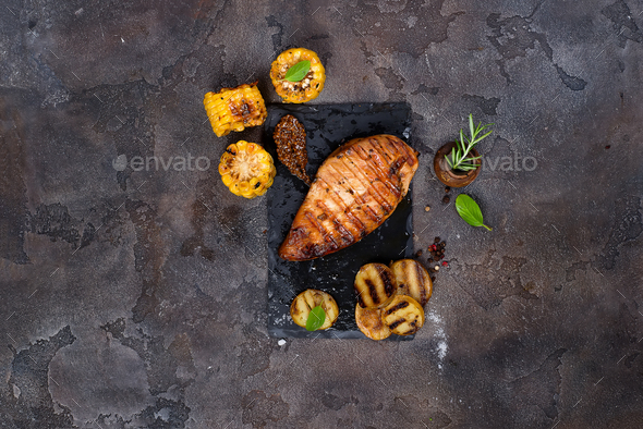 Marinated grilled healthy chicken breasts cooked on a summer BBQ - Stock Photo - Images