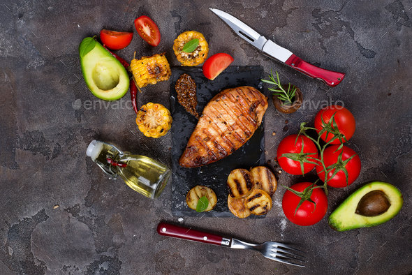 grilled healthy chicken breasts cooked on BBQ and served with fresh tomato, - Stock Photo - Images