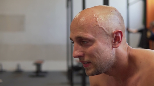 Exhausted Sweaty Fitness Man Resting After Workout at Gym
